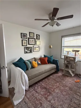 a living room with furniture and two window