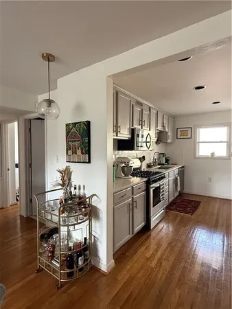 a kitchen with a sink cabinets and wooden floor