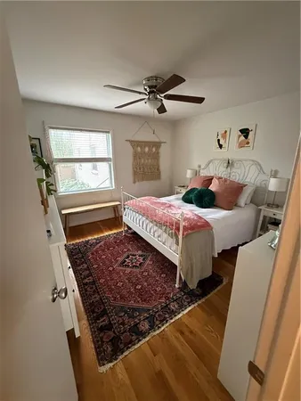 a bed sitting in a bedroom next to a window