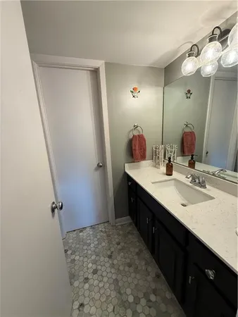 a bathroom with a double vanity sink and mirror