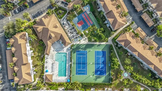 an aerial view of residential houses with outdoor space and swimming pool