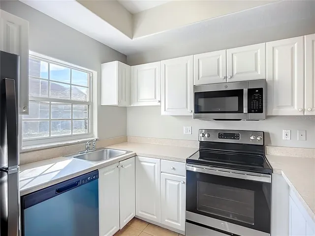a kitchen with a sink cabinets and a window