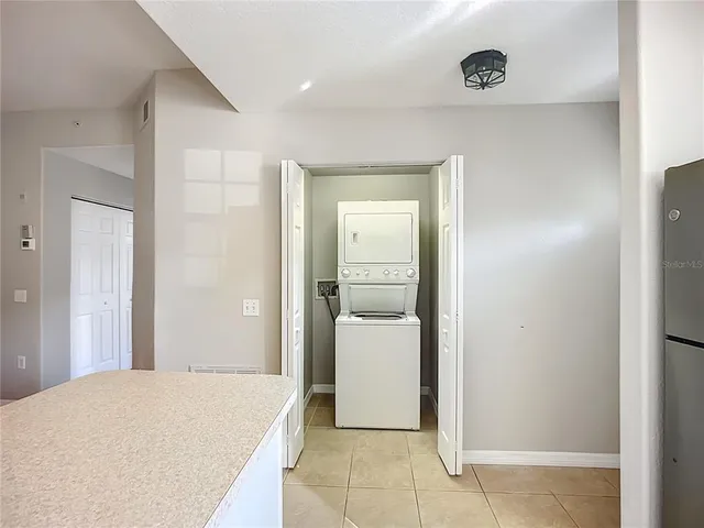 a view of a kitchen with a sink and a refrigerator
