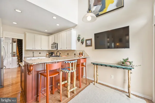 a kitchen with stainless steel appliances granite countertop a sink stove and cabinets