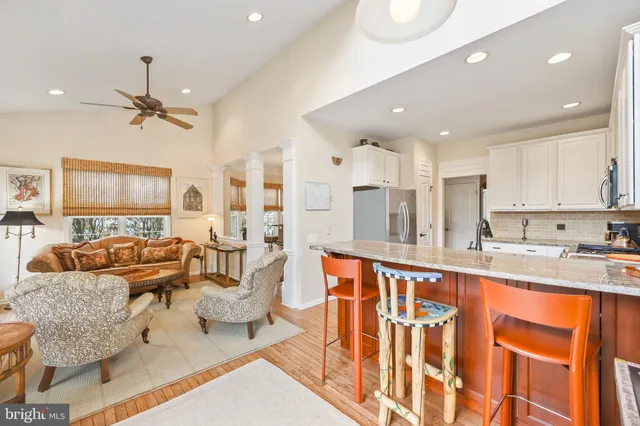 a kitchen with stainless steel appliances granite countertop a sink and a refrigerator