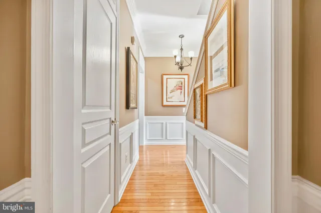 a view of an entryway with wooden floor and a front door