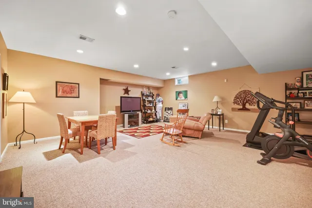 a living room with furniture a flat screen tv and a table