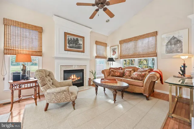 a living room with furniture a chandelier and a dining table