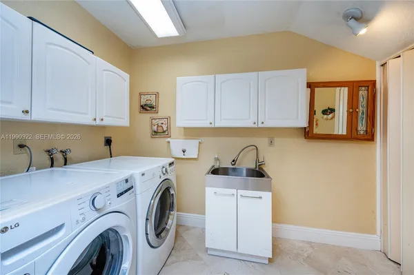 a spacious bathroom with a granite countertop tub and a large mirror