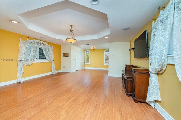 a bathroom with a granite countertop sink a toilet a mirror and shower