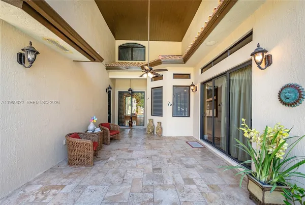 a view of a house with a chairs in patio