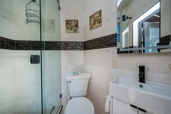 a view of a livingroom with wooden floor and a flat screen tv