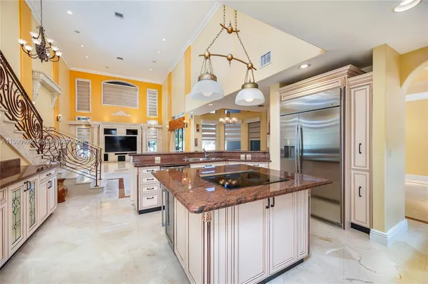 a kitchen with stainless steel appliances granite countertop a sink and a refrigerator