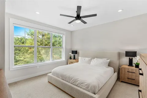 a bedroom with a large bed and a large window