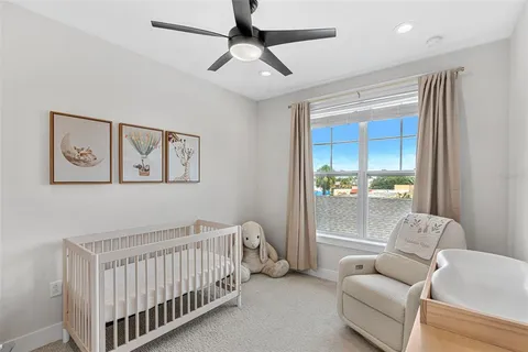 a bedroom with furniture and a large window