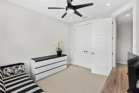 a bedroom with a bed and a ceiling fan