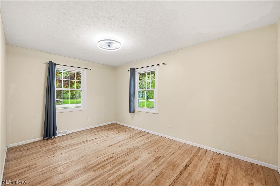 1515 Barlow Road Hudson, OH 44236 - Photo 18 of 31 Bedroom 3 with wood flooring, natural light, and huge walk-in closet and attached bathroom.