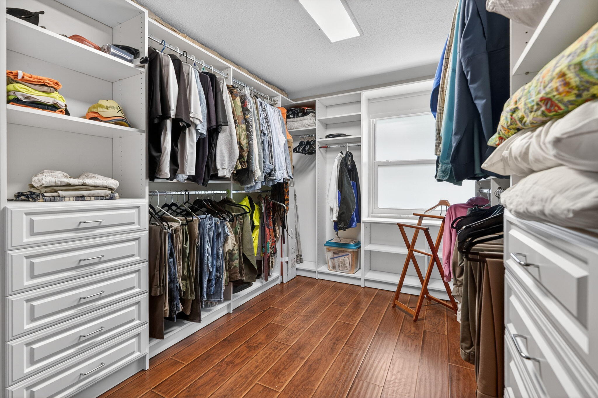 17391 Alexander Run Jupiter, FL 33478 - Photo 15 of 55 a view of walk in closet with clothes and shoes