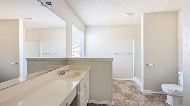a bathroom with a sink toilet and mirror