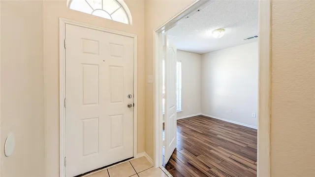 a view of a hallway with closet and bathroom