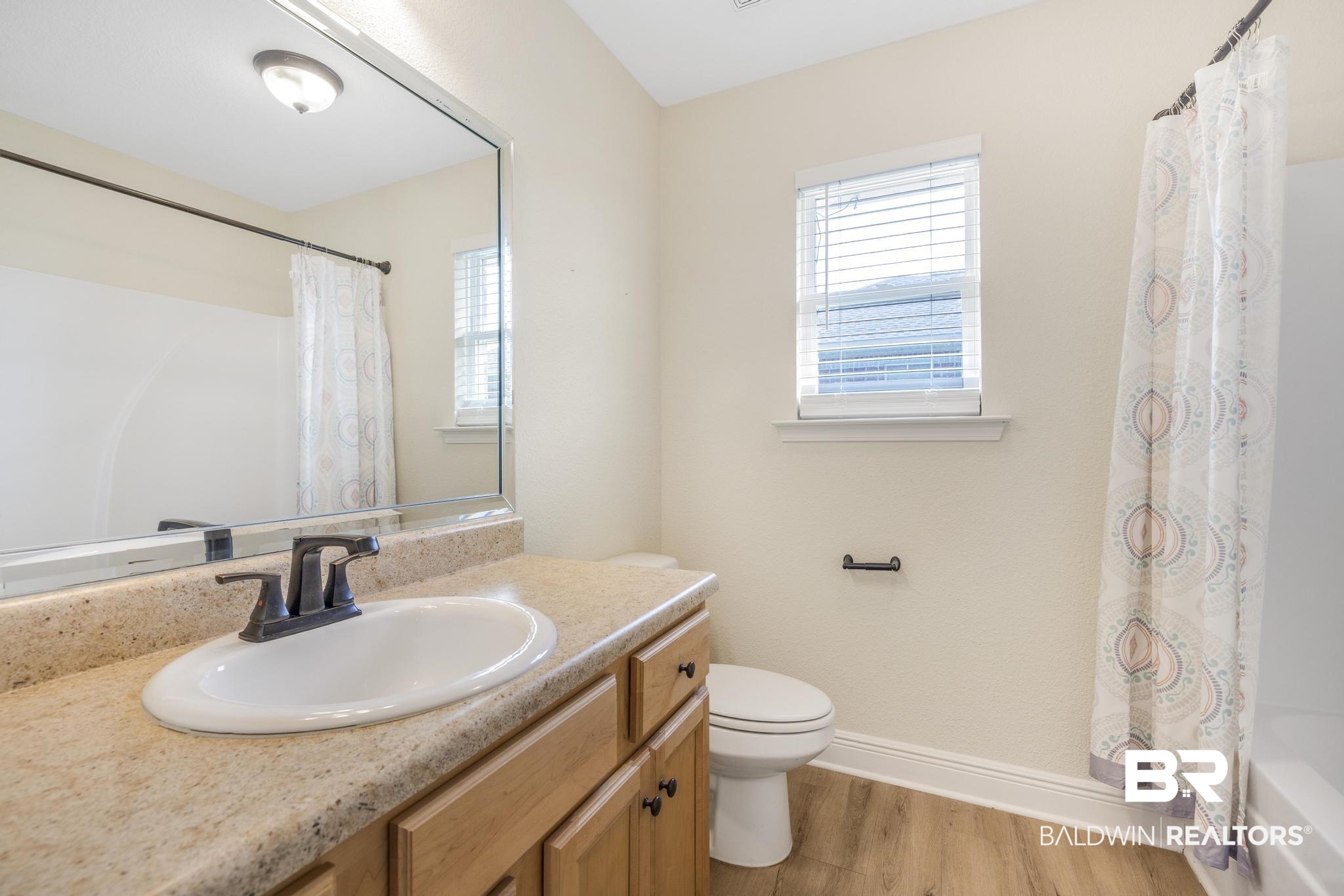 21580 Talbot Lane Robertsdale, AL 36567 - Photo 8 of 25 Bathroom with vanity, light wood-style flooring, and shower / tub combo