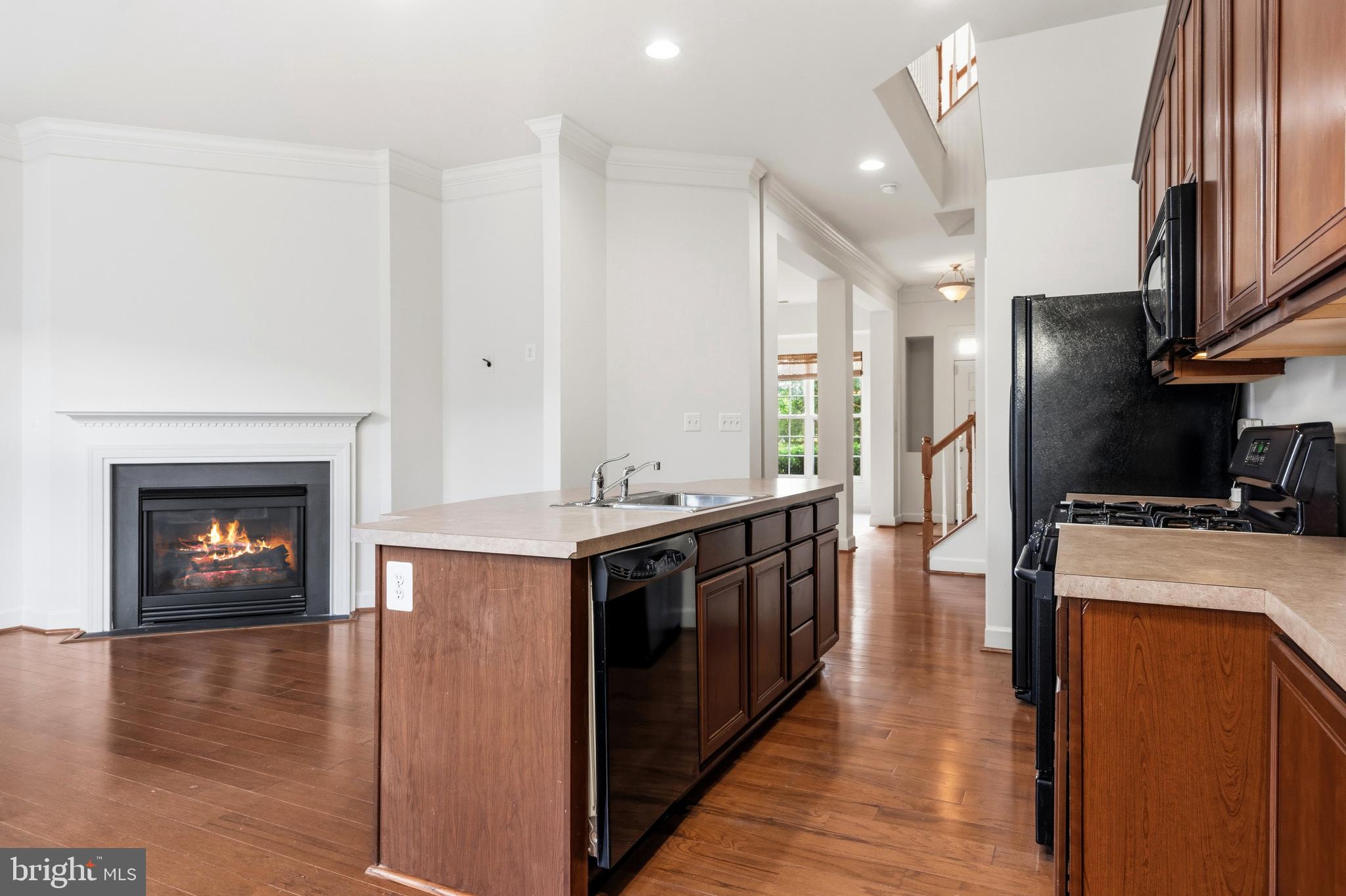 9227 Ribbon Falls Loop Bristow, VA 20136 - Photo 22 of 53 a kitchen with stainless steel appliances granite countertop a stove top oven a sink and a refrigerator