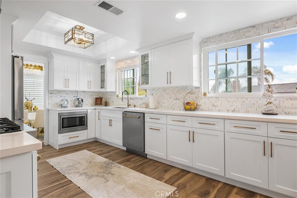 1216 Baseline Road La Verne, CA 91750 - Photo 11 of 37 a kitchen with cabinets stainless steel appliances a sink and a window