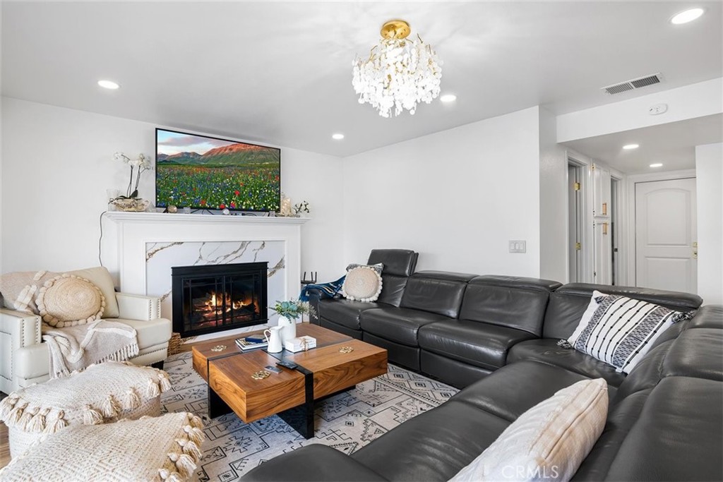 1216 Baseline Road La Verne, CA 91750 - Photo 22 of 37 a living room with furniture a flat screen tv and a fireplace