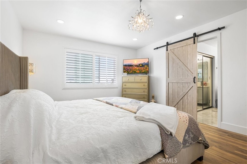1216 Baseline Road La Verne, CA 91750 - Photo 29 of 37 a bedroom with a bed and a chandelier
