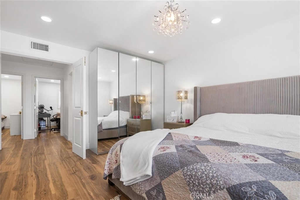 1216 Baseline Road La Verne, CA 91750 - Photo 30 of 37 a bedroom with a large bed and a chandelier