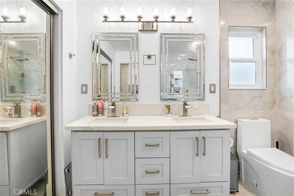 1216 Baseline Road La Verne, CA 91750 - Photo 31 of 37 a bathroom with a sink a toilet and a mirror