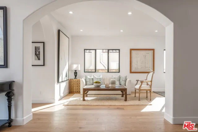 a living room with furniture and a table with chair