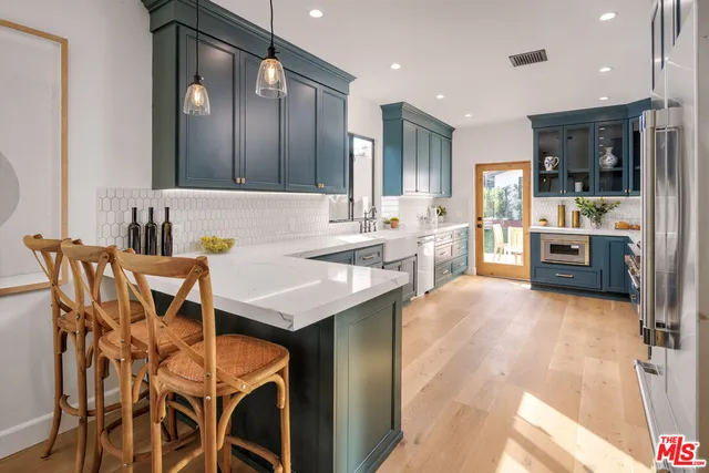 a kitchen with a table and chairs in it
