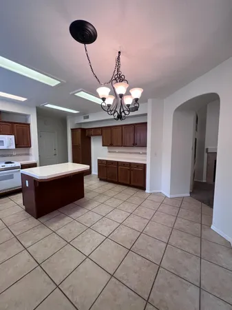 a kitchen with stainless steel appliances a sink a stove top oven a counter space and cabinets