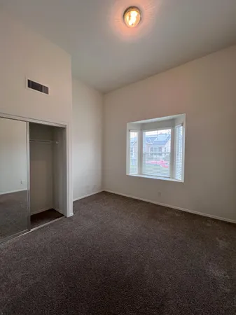 an empty room with a empty space and windows