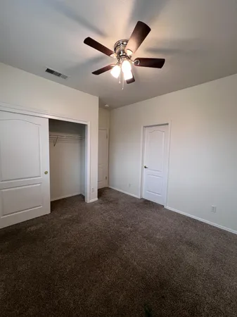 a view of a livingroom with a ceiling fan and window