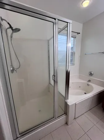 a spacious bathroom with a toilet sink and mirror