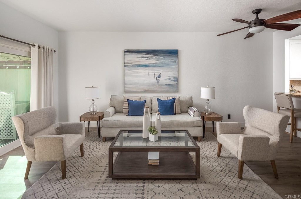 7777 Caminito Monarca, Unit 105 Carlsbad, CA 92009 - Photo 1 of 25 a living room with furniture and a large window