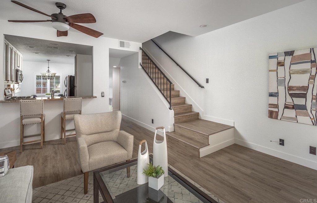 7777 Caminito Monarca, Unit 105 Carlsbad, CA 92009 - Photo 11 of 25 a living room with furniture and a wooden floor