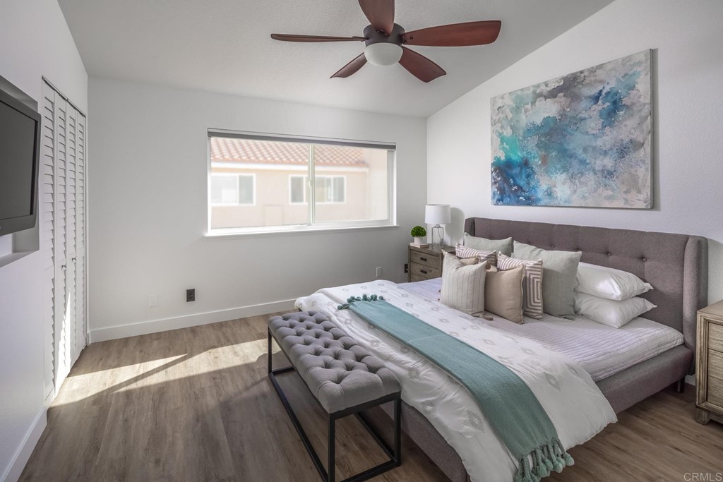 7777 Caminito Monarca, Unit 105 Carlsbad, CA 92009 - Photo 12 of 25 a bedroom with a bed and a painting on the wall