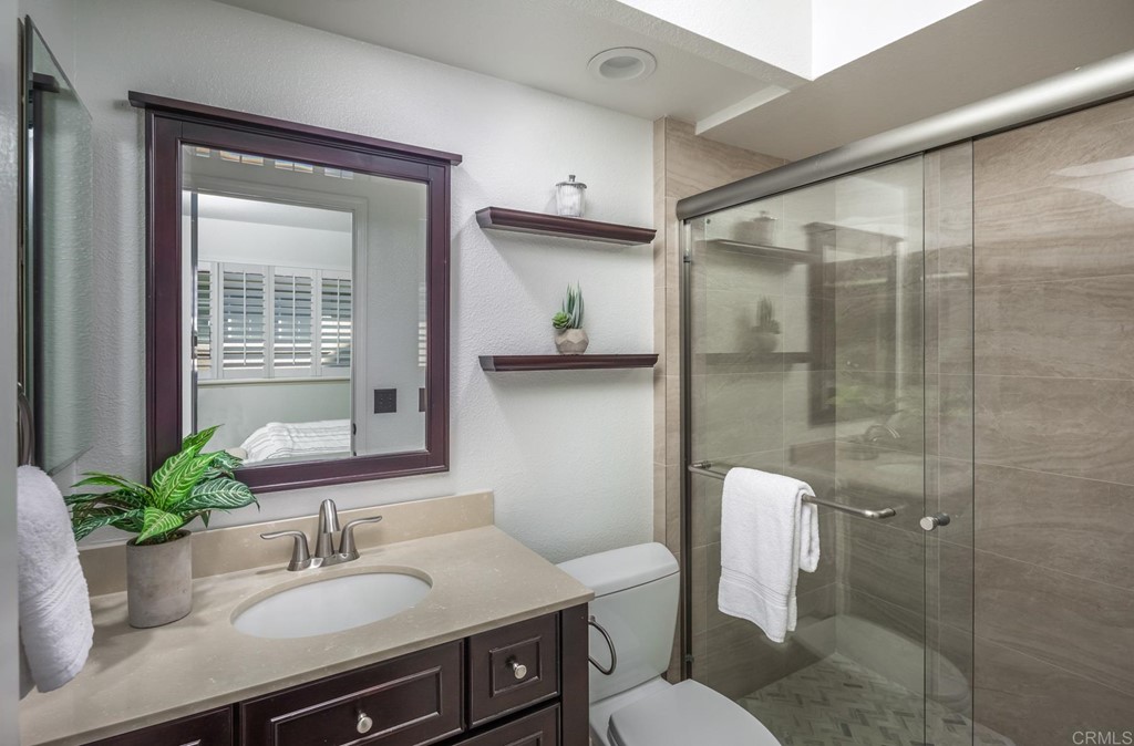 7777 Caminito Monarca, Unit 105 Carlsbad, CA 92009 - Photo 17 of 25 a bathroom with a sink toilet and shower