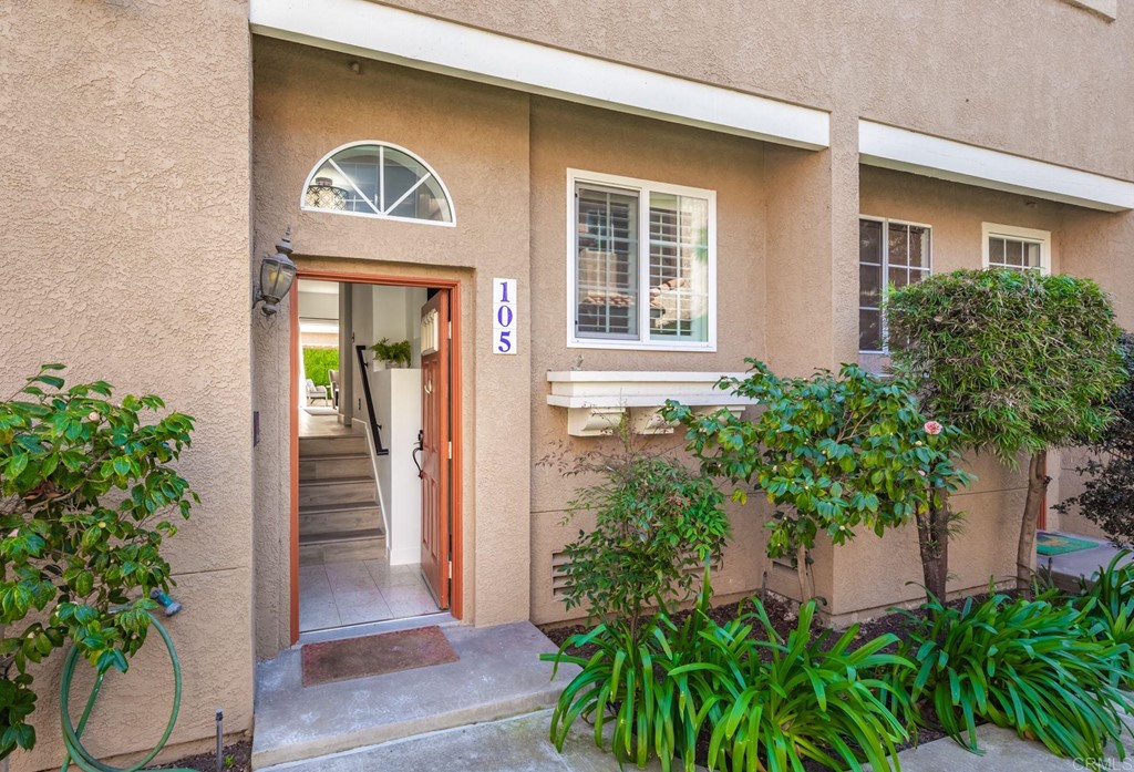 7777 Caminito Monarca, Unit 105 Carlsbad, CA 92009 - Photo 19 of 25 a front view of a house with a yard