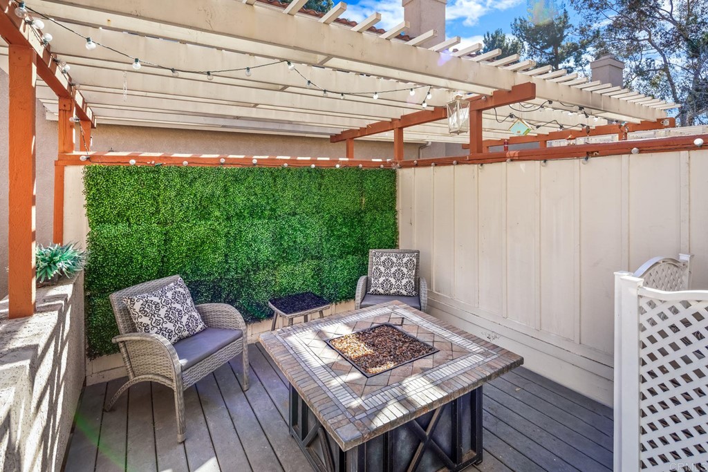 7777 Caminito Monarca, Unit 105 Carlsbad, CA 92009 - Photo 21 of 25 a view of a patio with table and chairs and wooden floor