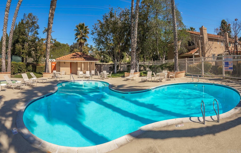 7777 Caminito Monarca, Unit 105 Carlsbad, CA 92009 - Photo 24 of 25 a backyard of a house with table and chairs