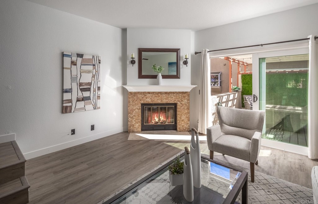 7777 Caminito Monarca, Unit 105 Carlsbad, CA 92009 - Photo 3 of 25 a living room with furniture and a fireplace