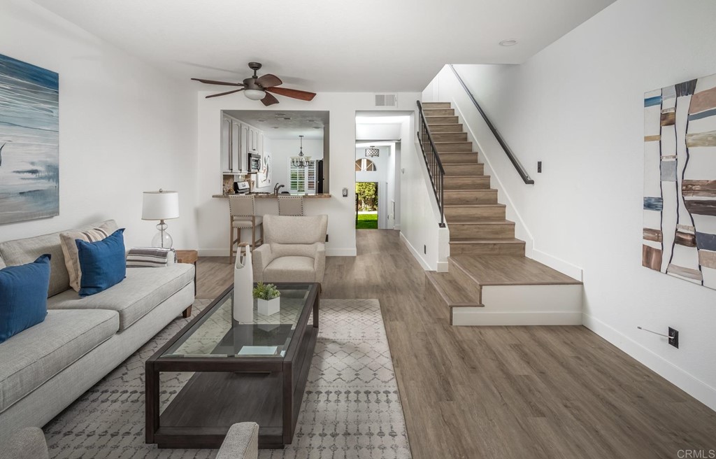 7777 Caminito Monarca, Unit 105 Carlsbad, CA 92009 - Photo 5 of 25 a living room with furniture and a wooden floor