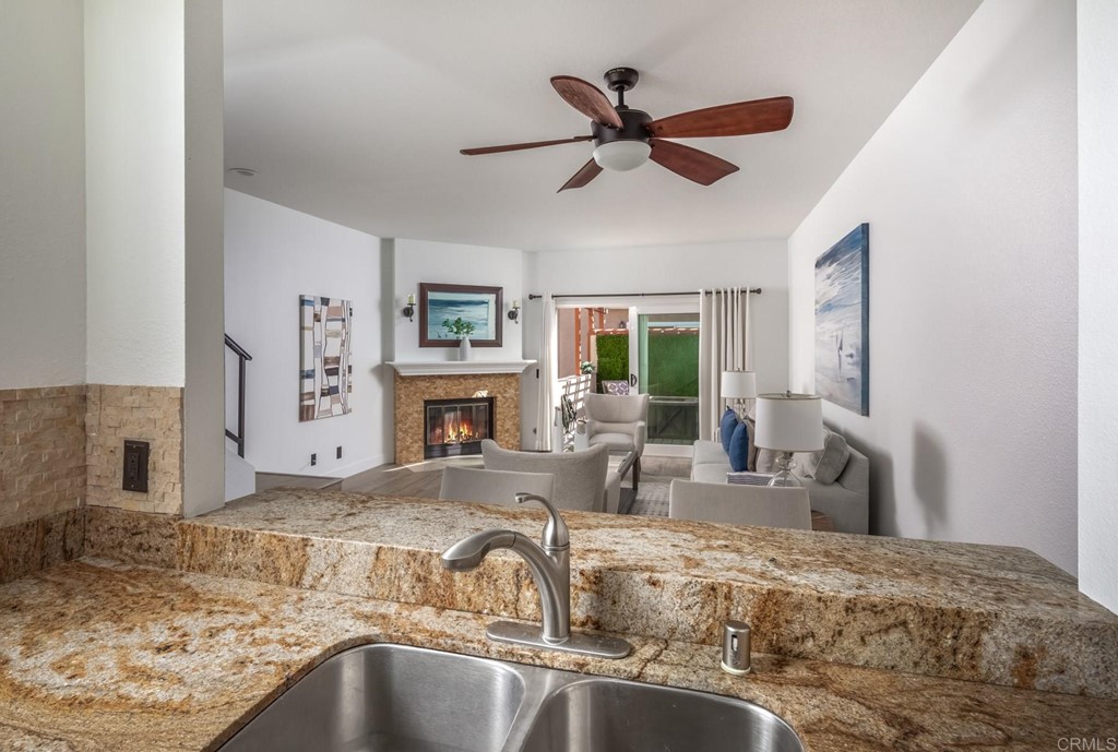 7777 Caminito Monarca, Unit 105 Carlsbad, CA 92009 - Photo 6 of 25 a view of a livingroom with a fireplace a sink and a window
