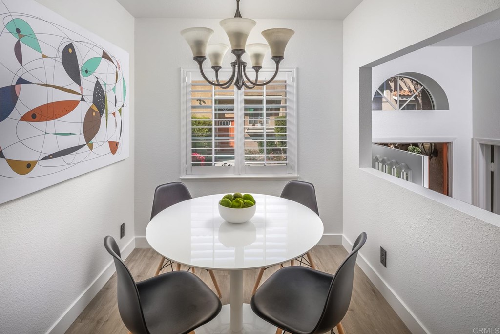 7777 Caminito Monarca, Unit 105 Carlsbad, CA 92009 - Photo 9 of 25 a view of a dining room with furniture and wooden floor