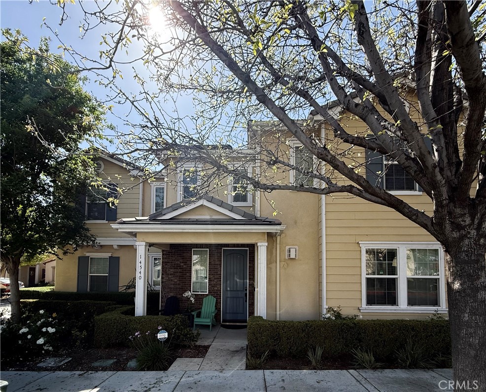 a front view of a house with yard and green space
