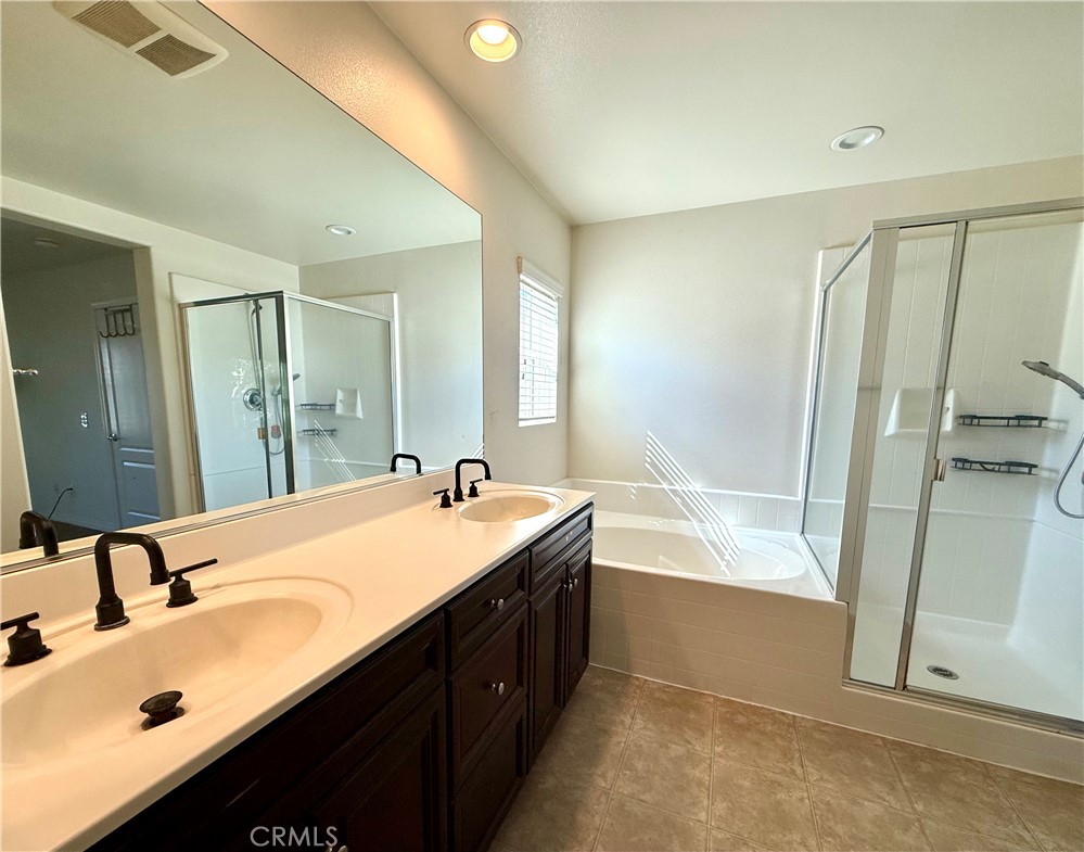 14540 Manchester Avenue Chino, CA 91710 - Photo 12 of 22 a bathroom with a tub sink double vanity and a mirror